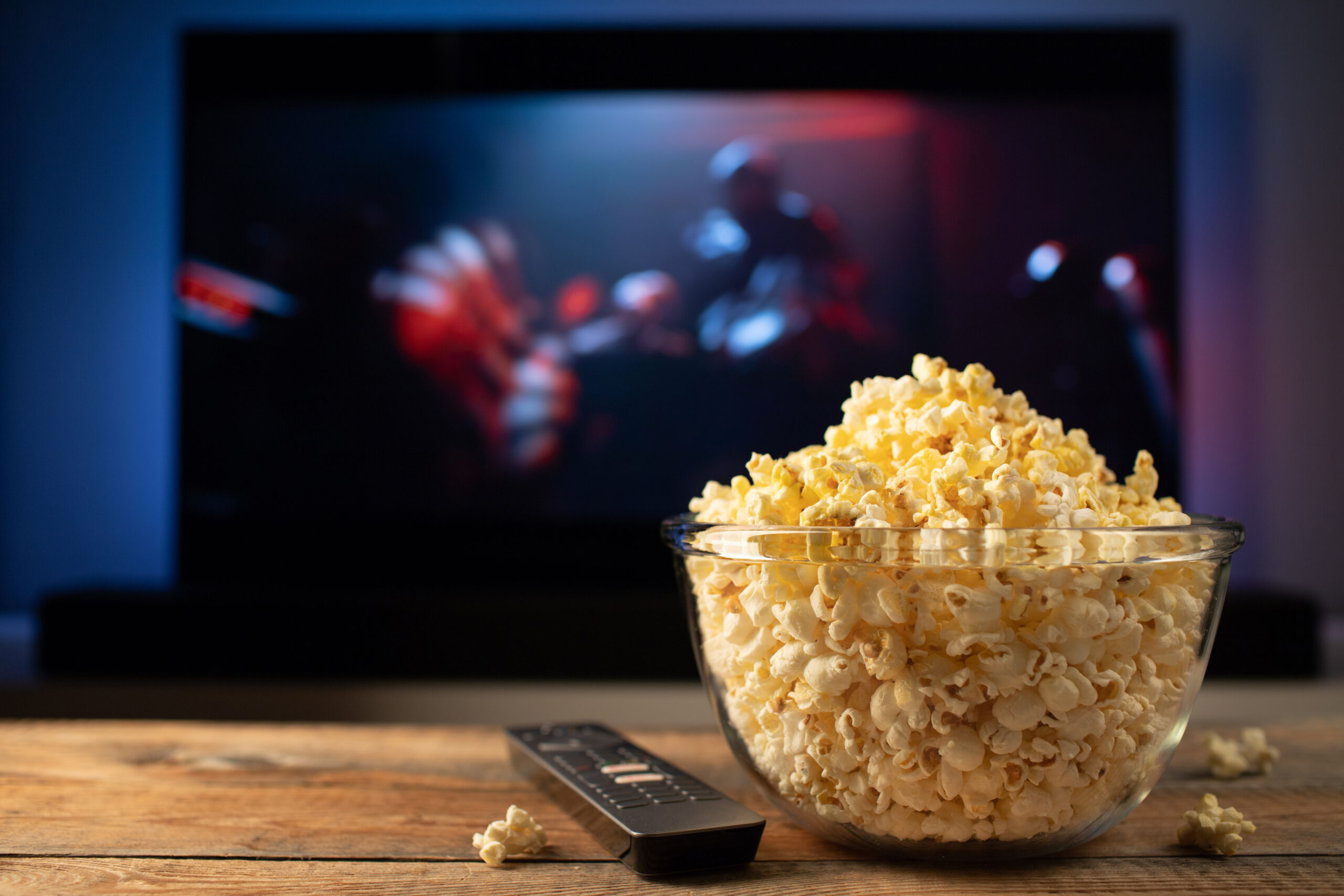 glass bowl popcorn remote control background tv works evening cozy watching movie tv series home scaled