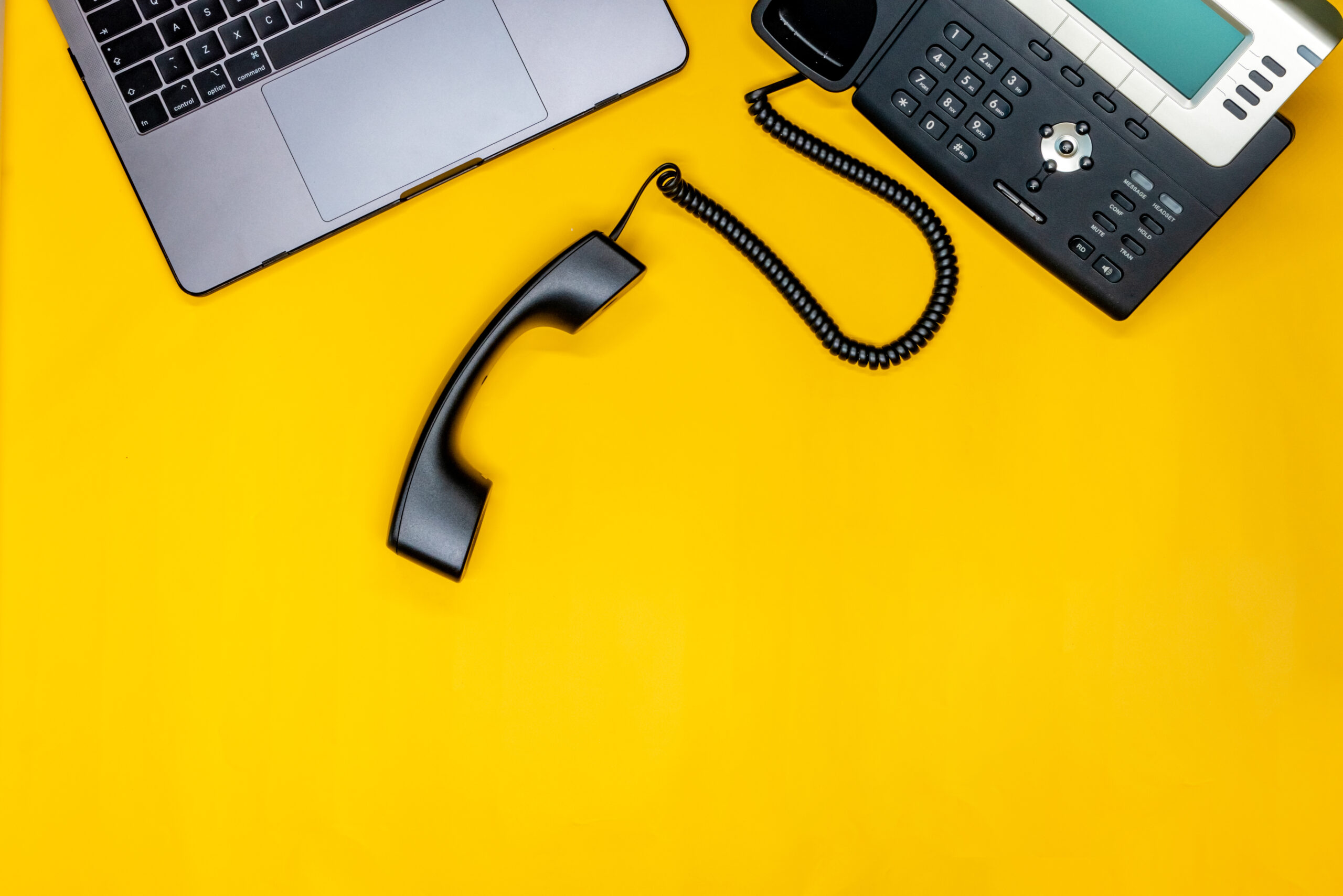 telephone laptop flat lay with workspace yellow background scaled